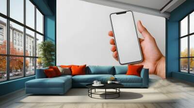 Horizontal mockup of a hand holding a mobile phone with a pure white screen set against a clean white backdrop  Minimalist design perfect for showcasing digital content apps or product presentations Wall mural