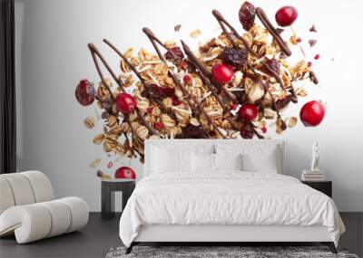 Cereal granola muesli with dark chocolate drizzle, filled with cranberries, walnuts, and nut berries, scattered on a white background Wall mural