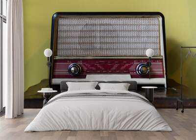 an old vintage radio standing on a wooden furniture Wall mural