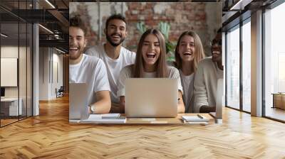 DIverse team of happy modern corporate company workers having fun at work. Group of joyful mixed race multiethnic people in T shirts and jeans with laptops and notebooks sitting Wall mural