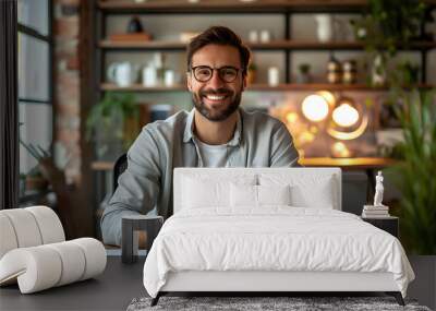 Grinning at the camera, a content freelancing man enjoys working remotely and being self-employed Wall mural