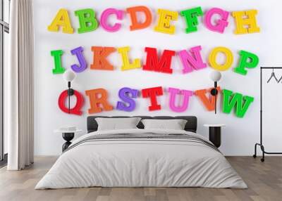 Colorful plastic alphabet letters on a white Wall mural