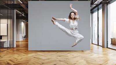 Beautiful young modern dancer or fitness dancer on a white isolated background Wall mural