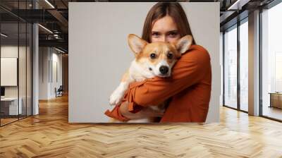 portrait of a girl and a corgi dog on a clean white background, love for animals Wall mural