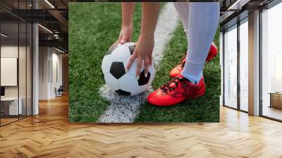 sports girl football player with a soccer ball on the soccer field, the concept of professional women's football Wall mural