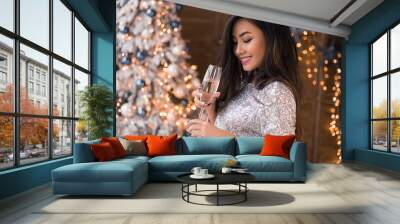 Cheerful asian lady in beautiful dress with a glass of champagne. Sexy smiling. Christmas party. Christmas Eve. X-mas, winter holidays and people concept Wall mural