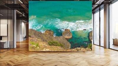 Aerial view over green turquoise water waves in Byron Bay, Australia. Nature background with ocean waters and rocks in sunny day. Wall mural