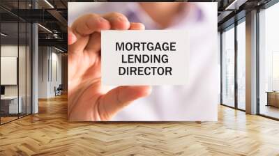 Businessman holding MORTGAGE LENDING DIRECTOR card Wall mural