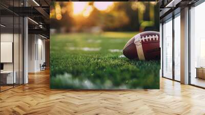 American football on a football field at sunset Wall mural