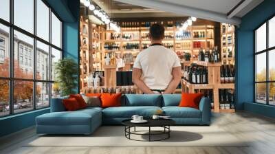 Back view. Wine shop owner in white shirt and black apron Wall mural