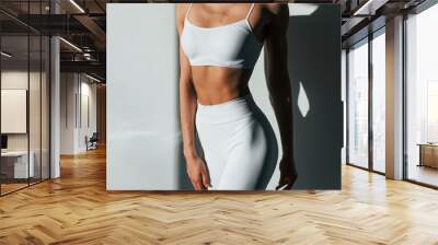 Beautiful lighting. Young caucasian woman with slim body shape is indoors at daytime Wall mural