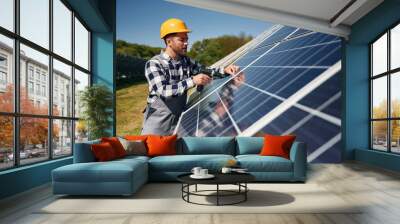 Checking the surface. Engineer with photovoltaic solar panels outdoors at daytime Wall mural