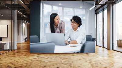 Cheerful coworkers in a modern office smiling when doing their job using laptop Wall mural