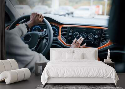 Close up view of african american woman's hands inside of new modern car Wall mural