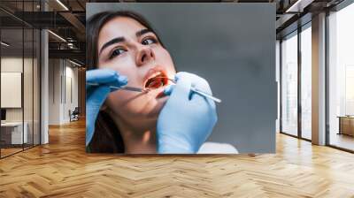 Close up view of young adult woman that have a visit in the dentist clinic. Conception of stomatology Wall mural