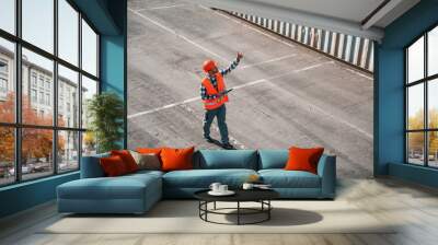 Conception of business. Walking with tablet. Male worker is on the location with containers Wall mural