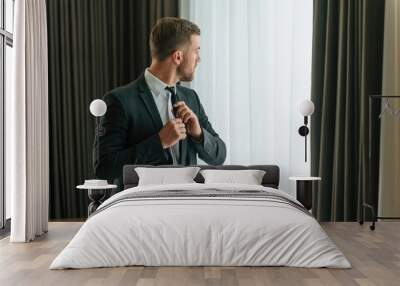 Conception of elegance. In suit and tie. Businessman is indoors in the hotel room Wall mural