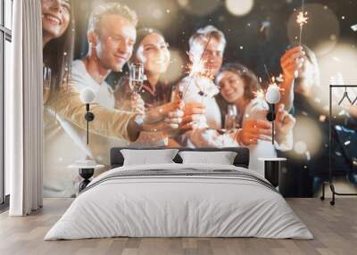 Group of cheerful young people have party and celebrating new year indoors Wall mural