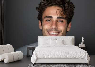 Handsome young man smiling in a studio portrait Wall mural