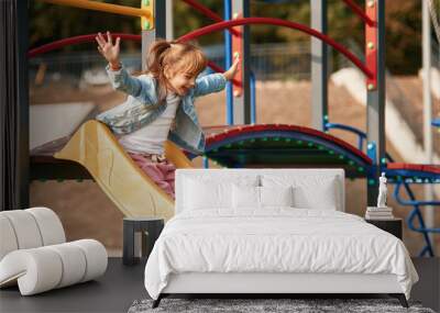 Little girl is having fun on the playground Wall mural