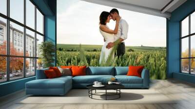 Lovely couple are on the agricultural field together Wall mural