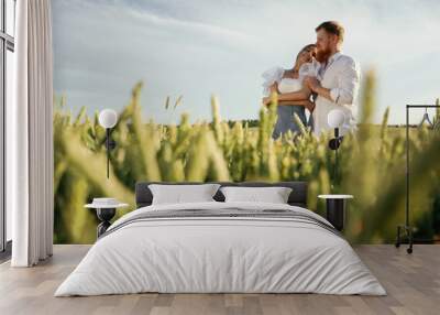 Non urban view, leisure. Lovely couple are on the green agricultural field together Wall mural