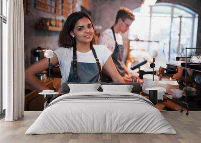 Positive mood. Two young cafe workers indoors. Conception of business and service Wall mural