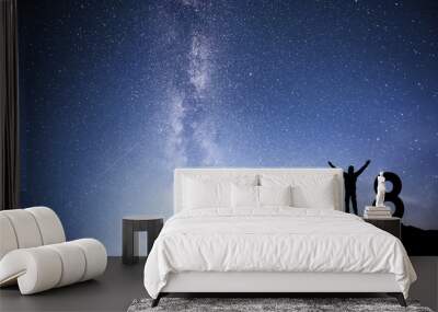 Silhouette young man Happy for 2018 new year background of the Milky Way galaxy on a bright star dark sky tone Wall mural