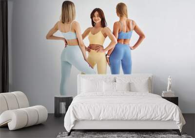 Slim body type. Beautiful women in sportive clothes is indoors in the studio Wall mural