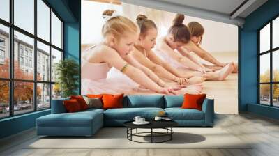 Stretching exercises. Little ballerinas preparing for performance Wall mural