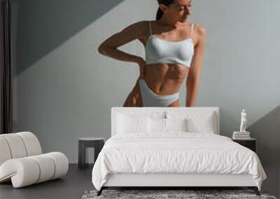 Tall figure. Young caucasian woman with slim body shape is indoors in the studio Wall mural