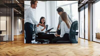 Young business people in formal clothes working in the office Wall mural