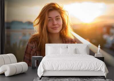 Young woman enjoying coffee on balcony at sunrise Wall mural