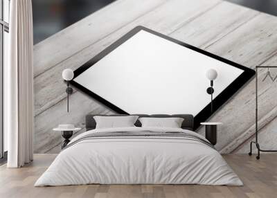 Black tablet on wooden table with isolated white screen for mockup. Horizontal position isometric view. Wall mural