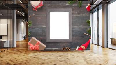 Christmas picture frame for photo or greeting text mockup. Top view scene on wooden table. Gifts and tree beside. Wall mural