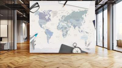 Concept of travel organization. Airplane model, passport, compass, glasses, pad and pencil on world map. Copy space in the middle. Top view, flat lay. Wall mural