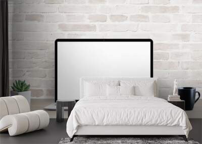 Laptop mockup on simple, clean desk with brick wall in background. Isolated screen for ap, web site resentation. Plant and cup of coffee on table Wall mural