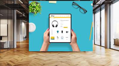 Online shoping with tablet concept. Girl use e-commerce web site for buy headphones. Top view, flat lay Wall mural