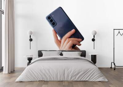 Woman hand shows a modern phone with three cameras on the back. Isolated background Wall mural