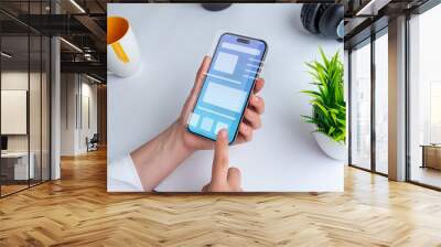 Woman holding a smartphone with a conceptual user interface. The interface showcases a clean design with vibrant colors and intuitive navigation elements Wall mural