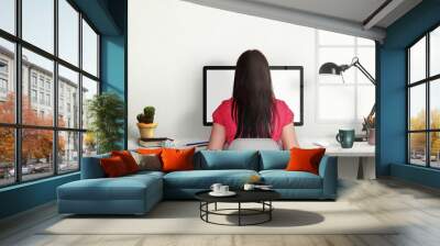 Woman work on office computer with isolated screen for mockup. Modern office interior with window, lamp, plant, coffee, pencils. Wall mural