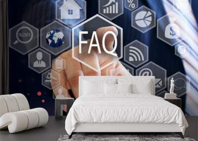 The businessman chooses  FAQ  button on the touch screen with a futuristic background .The concept FAQ  . Wall mural