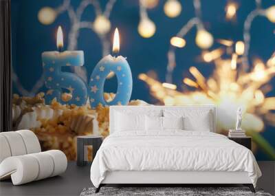 Birthday cake with 50 number candles and burning sparkler on blue backgraund. Close-up Wall mural