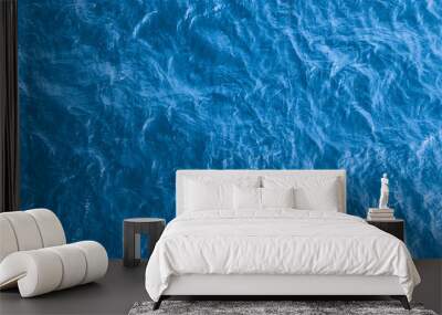 Beautiful sea background - blue water surface with small ripples, top view Wall mural