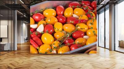 Cooking homemade confit - colorful cherry tomatoes with garlic, pepper and thyme with olive oil in a baking sheet, close-up - french country cuisine Wall mural