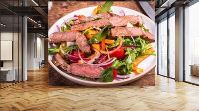 Healthy vegetable salad with beef steak on a plate, rustic style, close-up. Wall mural