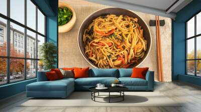 Traditional Chinese vegetarian noodles lo mein on a plate with chopsticks, top view Wall mural