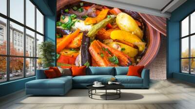 Vegetarian dish, homemade tajine or tagine with potatoes, eggplants, zucchini and pepper, close-up - traditional Moroccan and Tunisian cuisine Wall mural