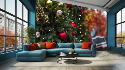 Winter Christmas holiday background - Christmas tree branch with toys and blurred park bench in the background Wall mural