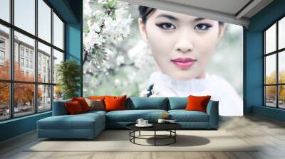 Young woman with cherry flowers Wall mural